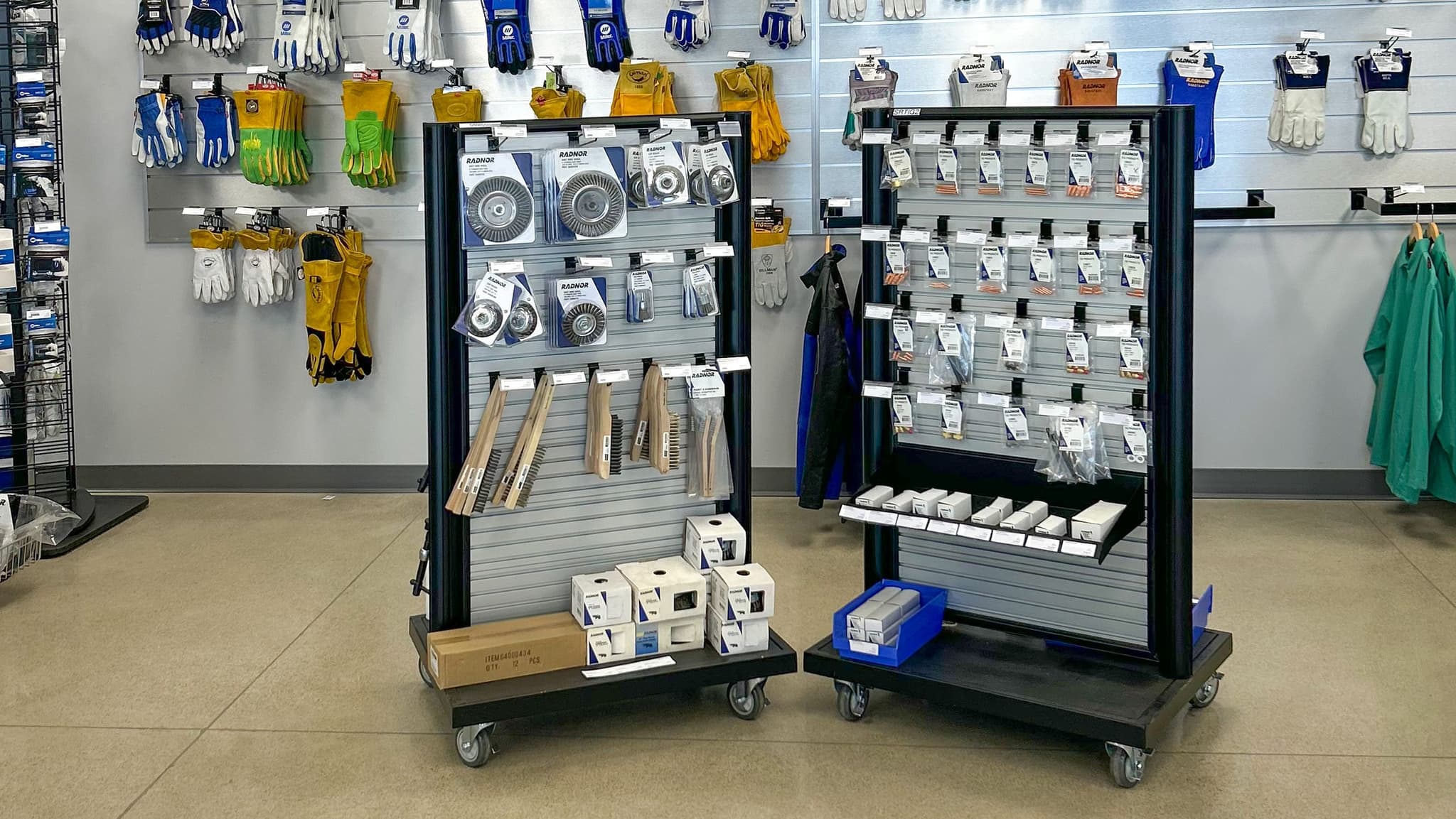Portable NeXtrac slatwall gondolas display tools and safety gear on the sales floor of an Airgas store.