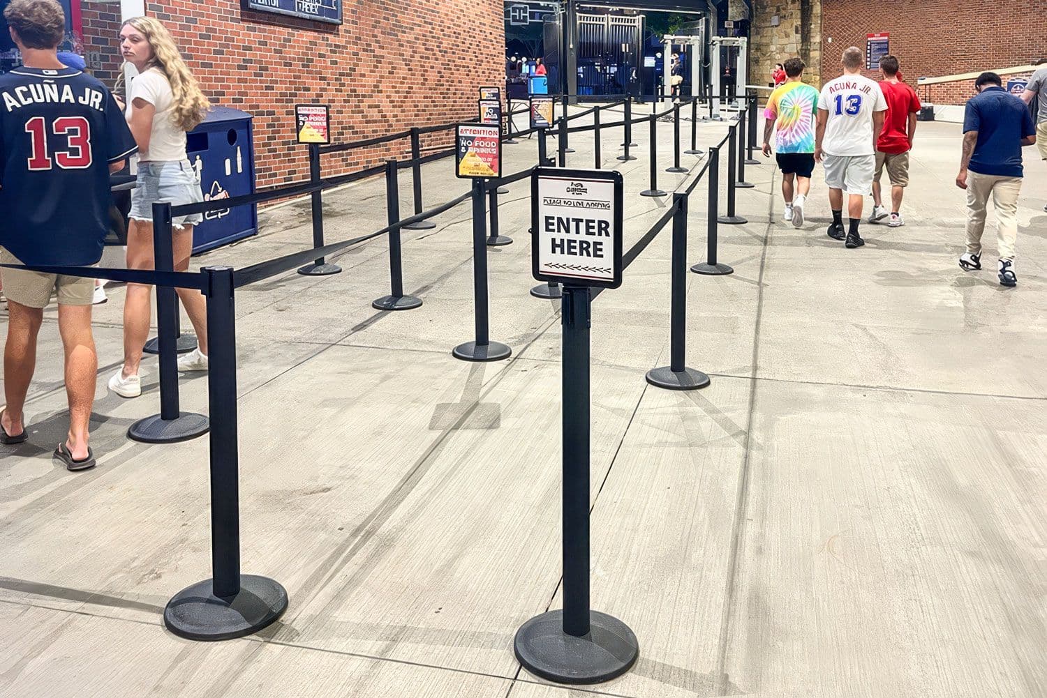 Beltrac retractable belt stanchions with a post-top sign organize the concession line at the Atlanta Braves stadium.