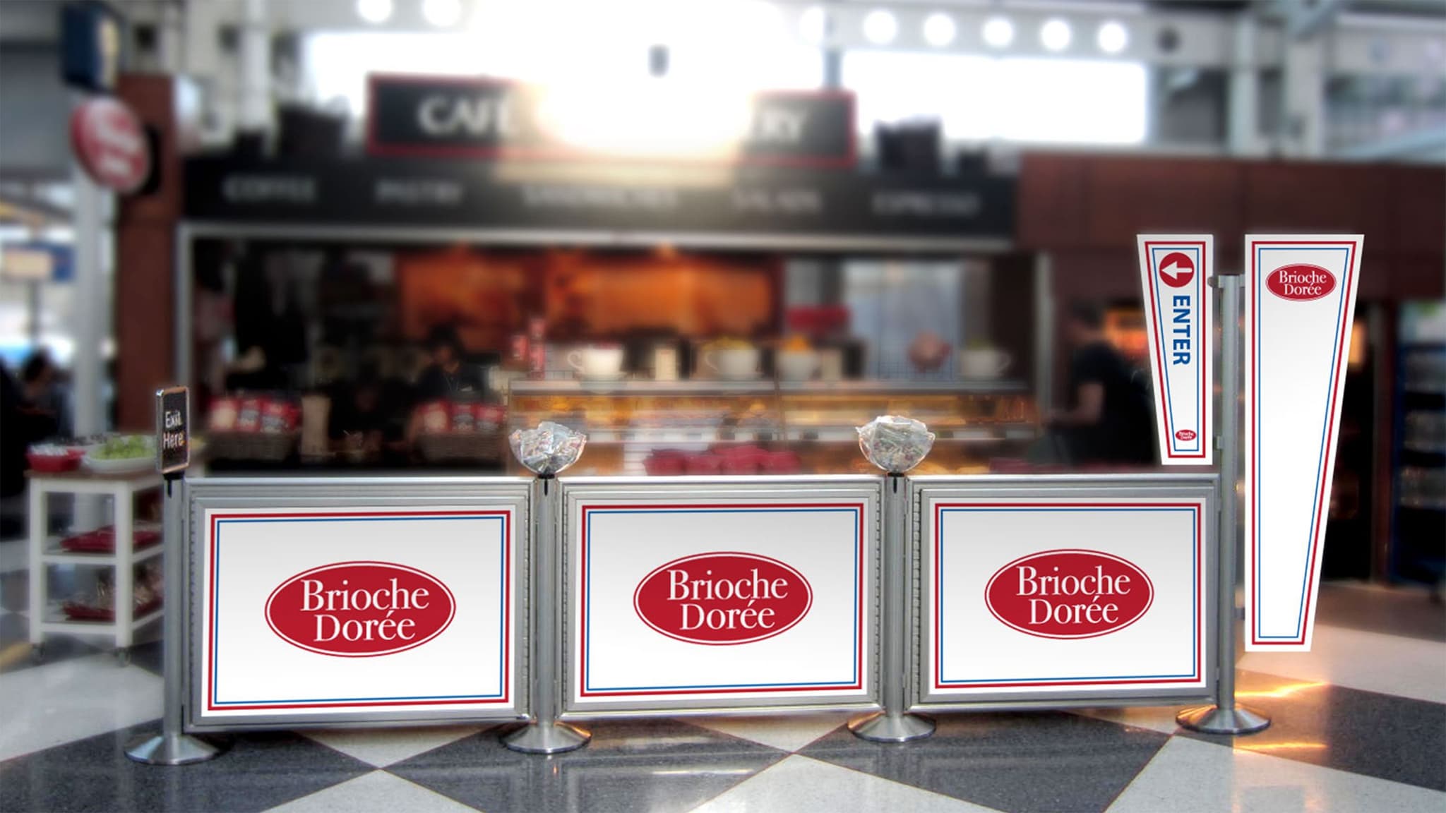 A NeXtrac merchandised queue with post-top signs leads customers to the Brioche Doree counter inside an airport terminal.