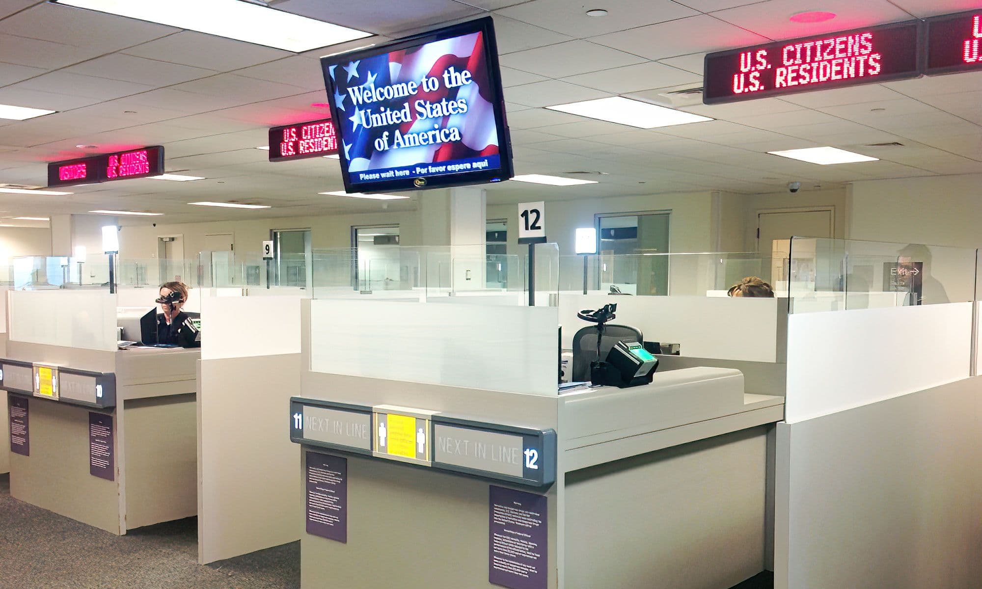 An electronic queuing system with overhead displays calls customers to the next open window at a Broward County government office.