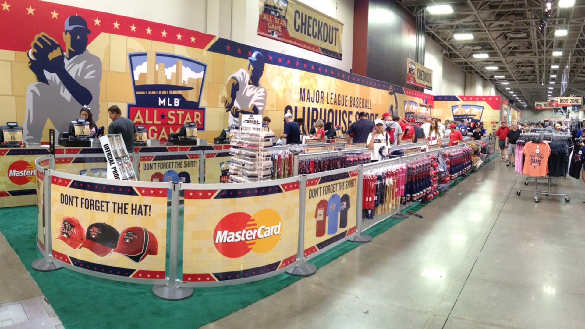 Post and Panel barriers with printed graphics and slatwall displays organize the checkout queue at the MLB All-Star Game store.