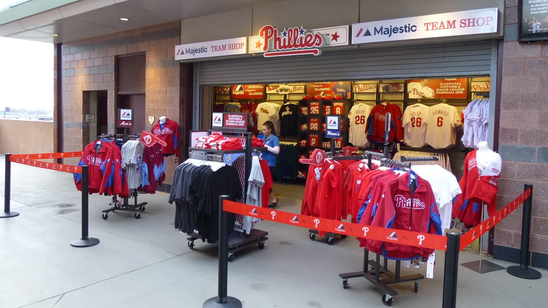 Beltrac retractable belt stanchions with custom printed four-inch belts guide fans through a team store checkout line.