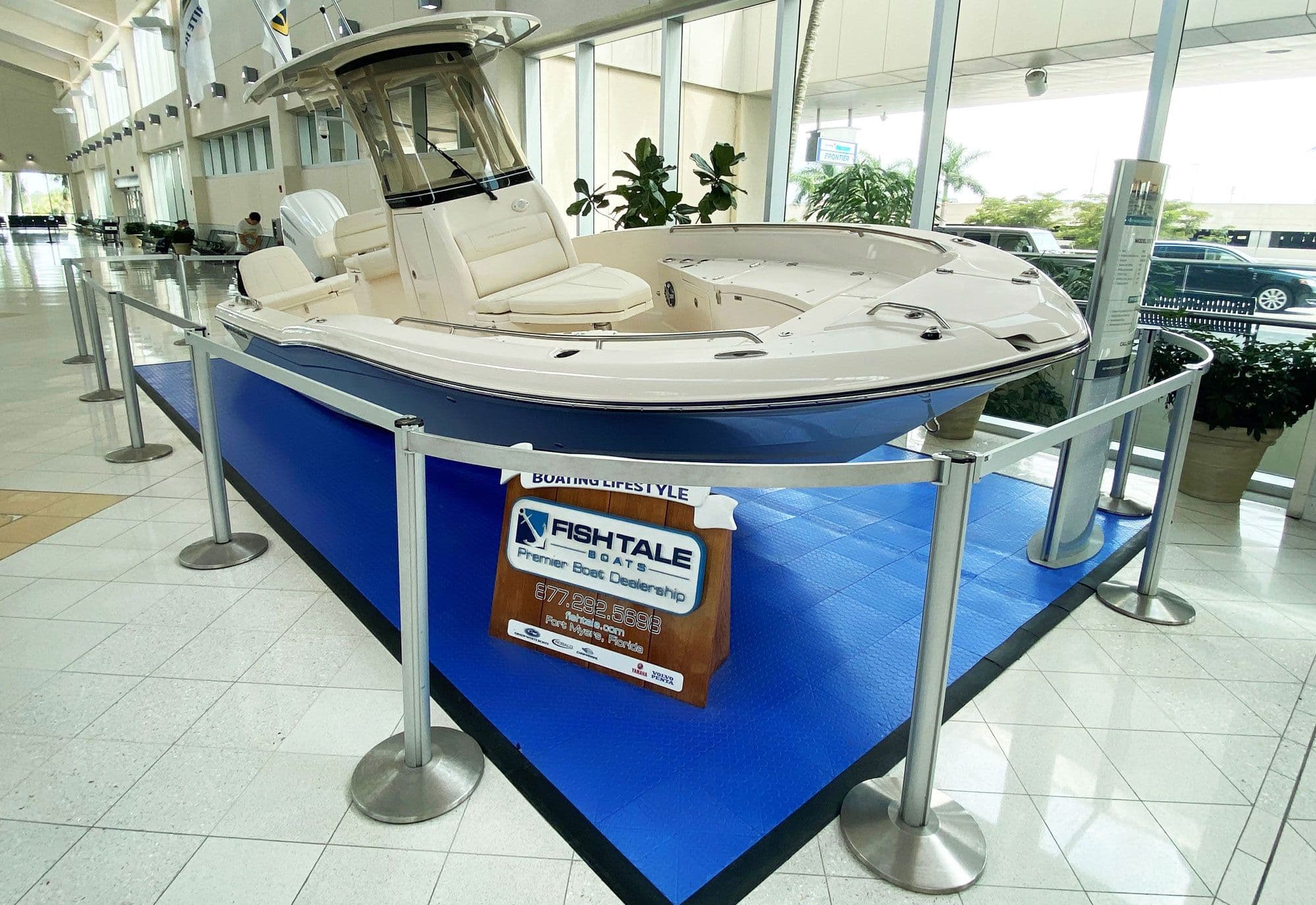 A curved Rigid Rail barrier guards a product display on a retail sales floor.