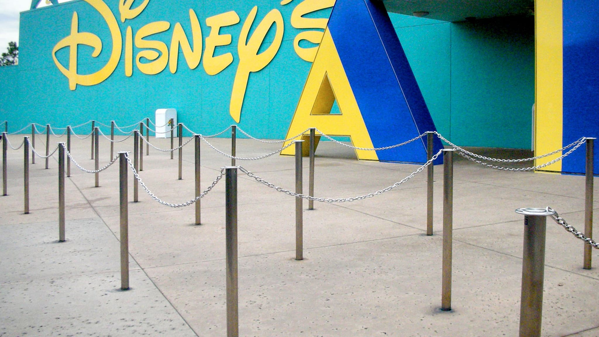 Permanent traditional posts with chain guide guests through an attraction queue at a Disney resort in Florida.
