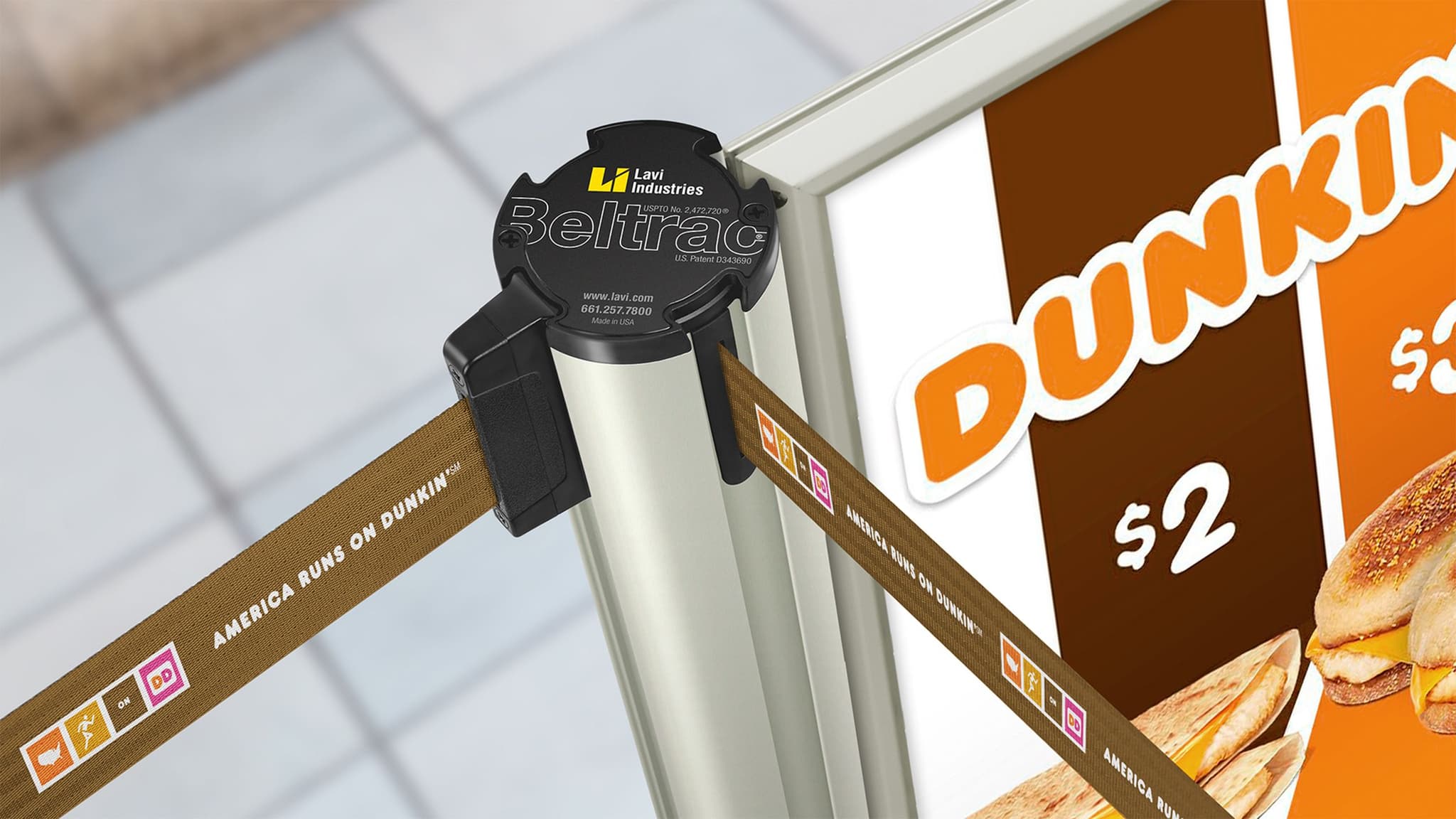 Beltrac retractable belt stanchions with custom printed Dunkin' belts guide customers to the counter.