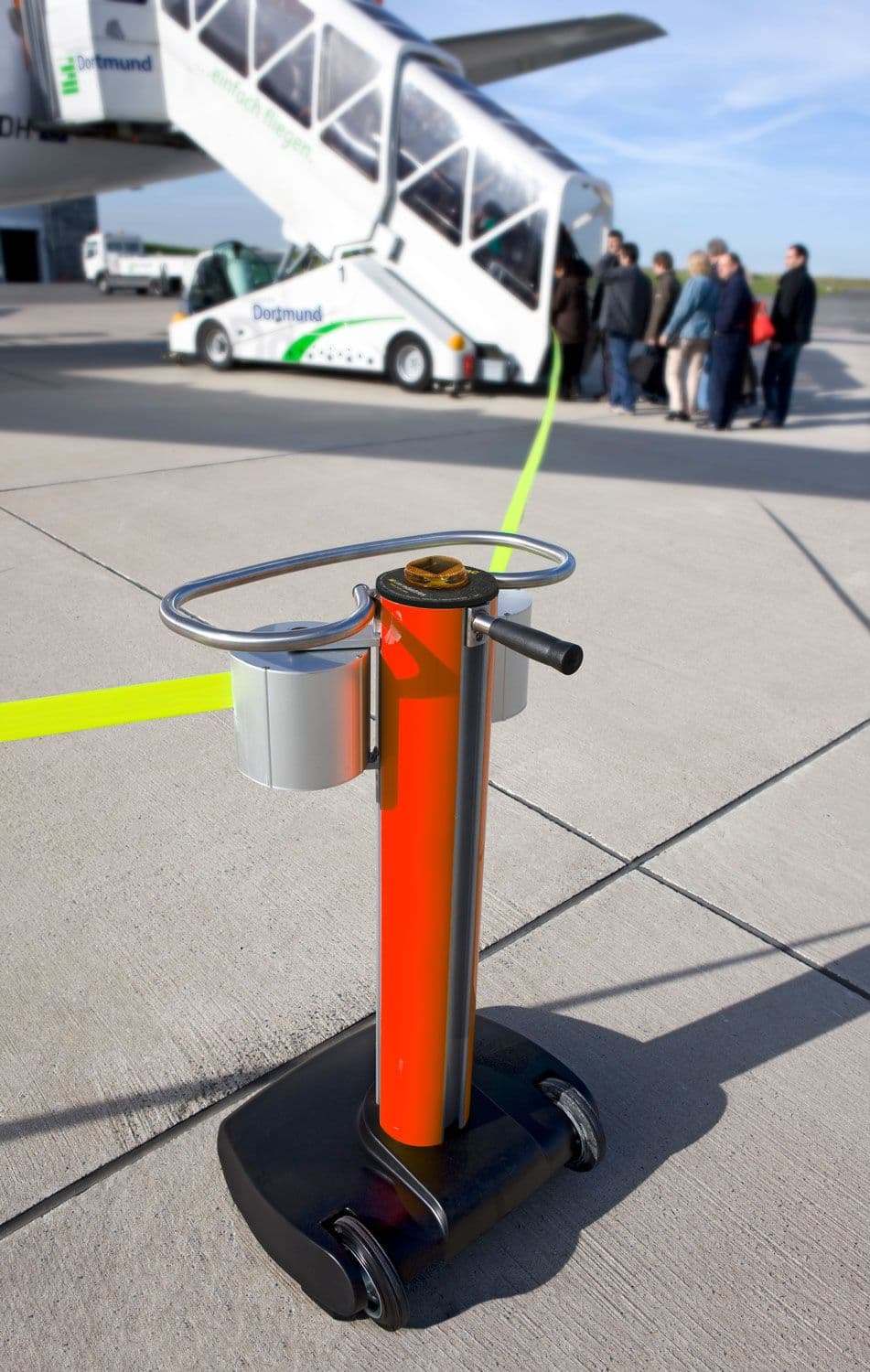 A JetTrac retractable belt barrier guides passengers boarding an aircraft from the apron.