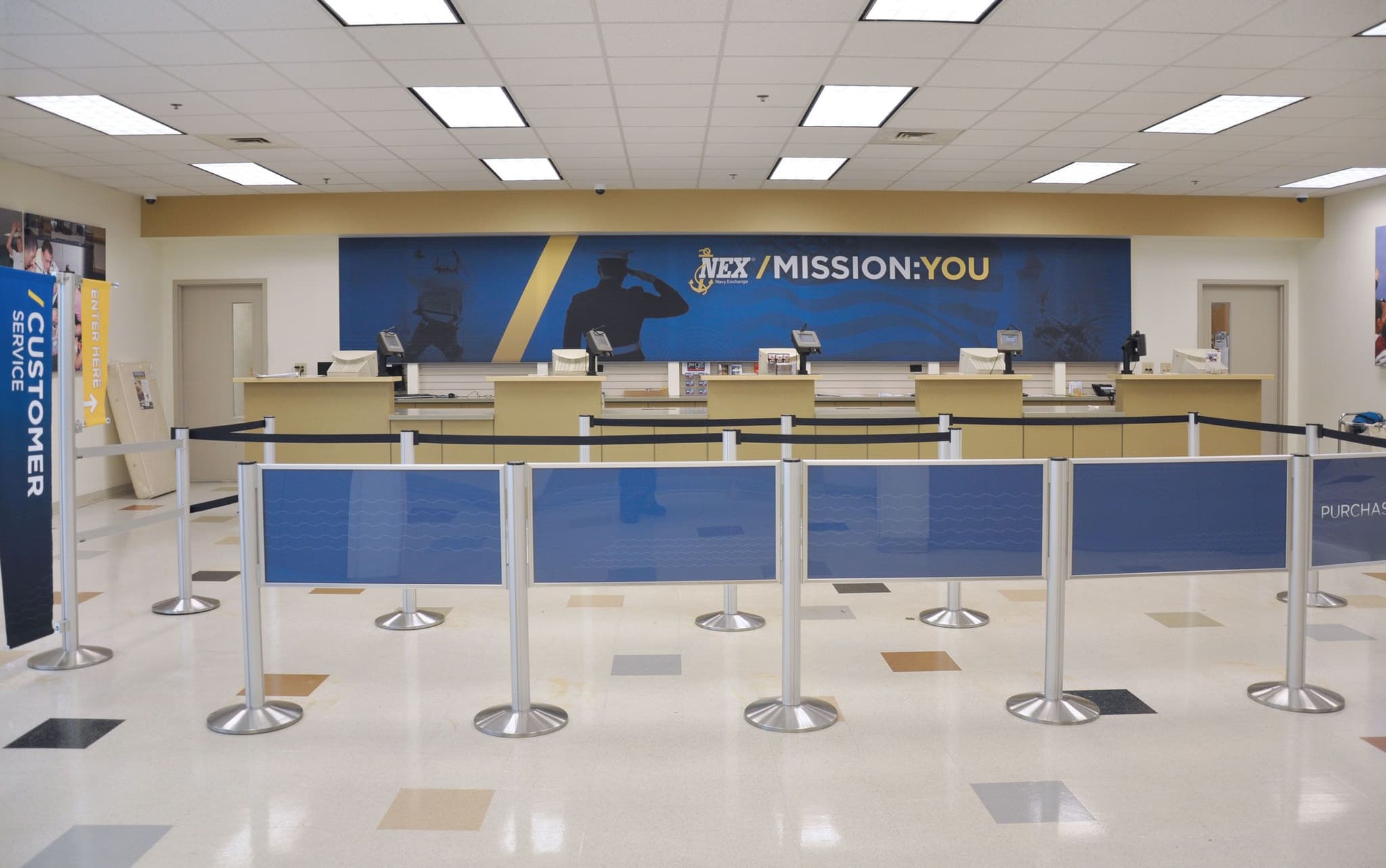 Post and Panel barriers guide customers to the service counter at a Navy Exchange store.