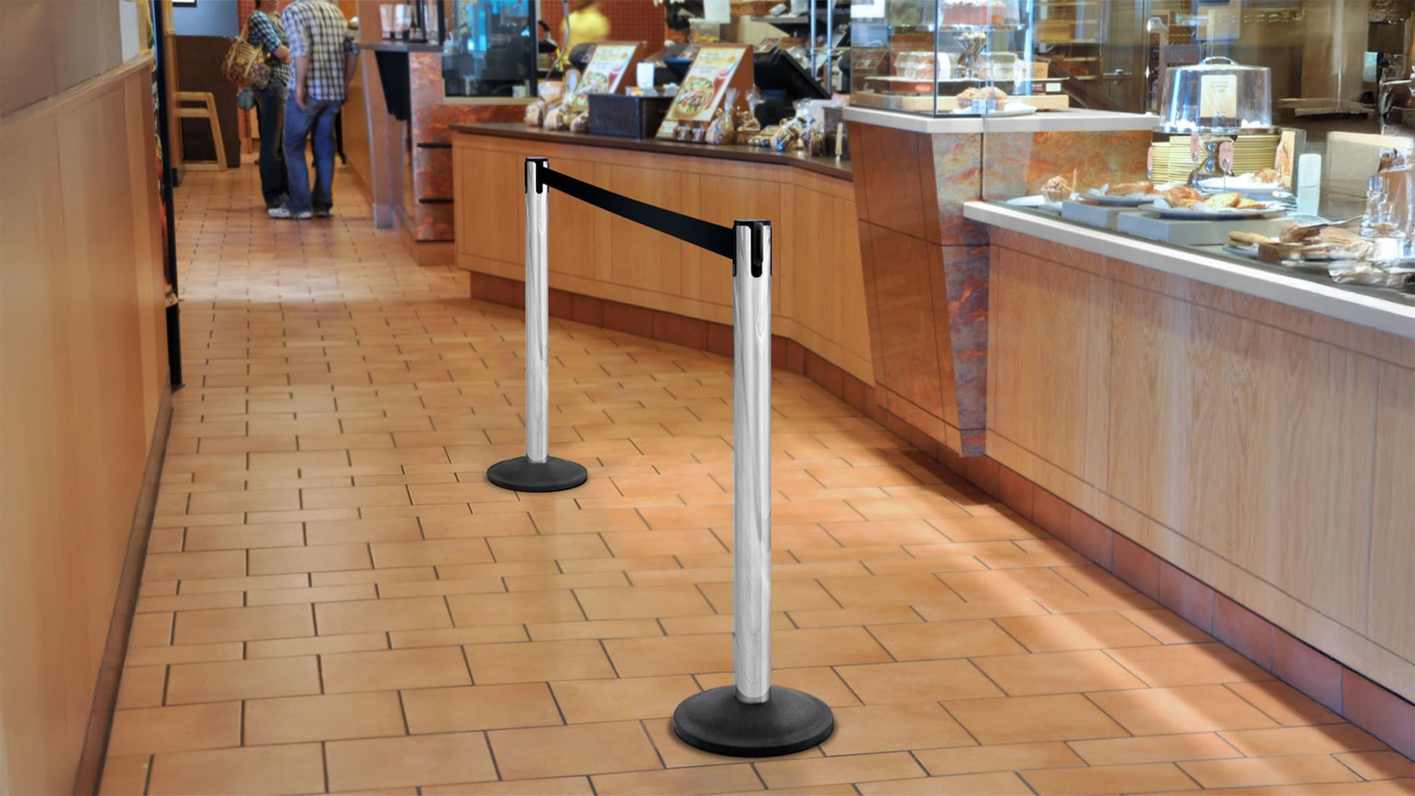 Beltrac retractable belt stanchions guide customers to the counter inside a Panera restaurant.