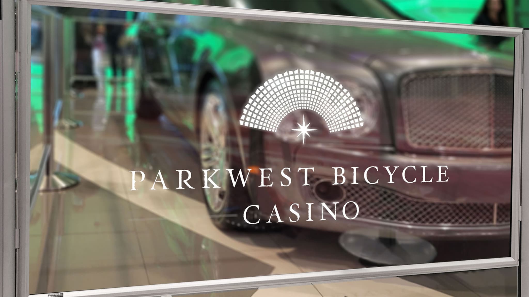 A Post and Panel barrier with a custom etched panel guides guests at the Parkwest Bicycle Casino.