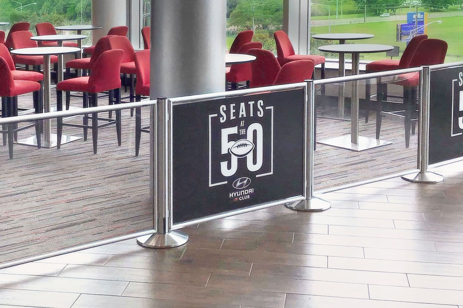 A Post and Panel barrier with custom printed graphics guides fans at Raymond James Stadium in Tampa.