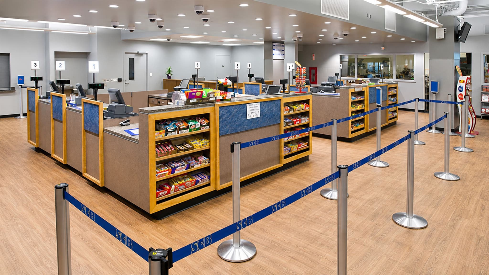 Beltrac retractable belt stanchions organize the checkout queue at a college campus bookstore.