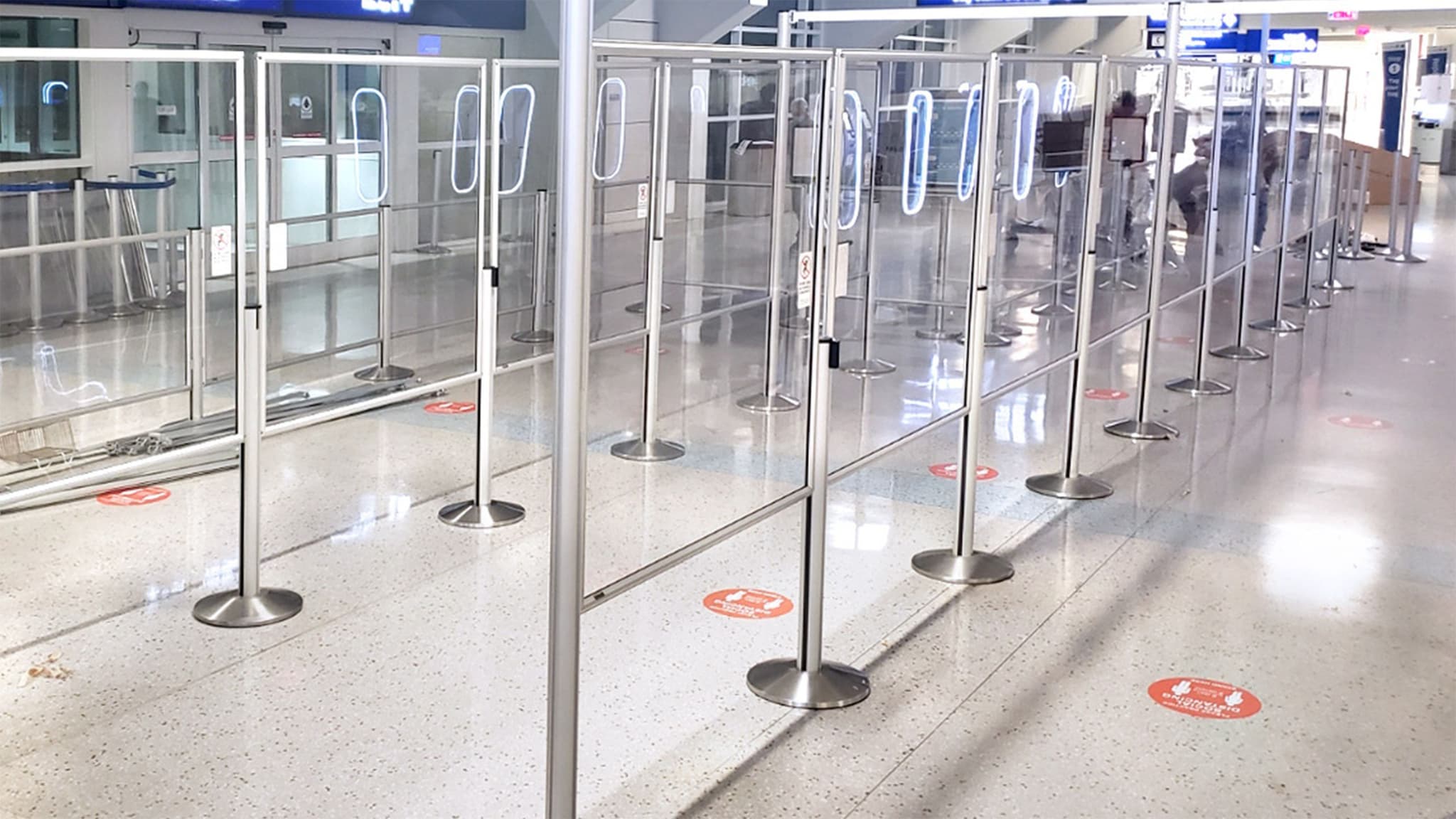Beltrac retractable belt stanchions with Queue Guard panels form the security queue at Dallas Fort Worth International Airport.