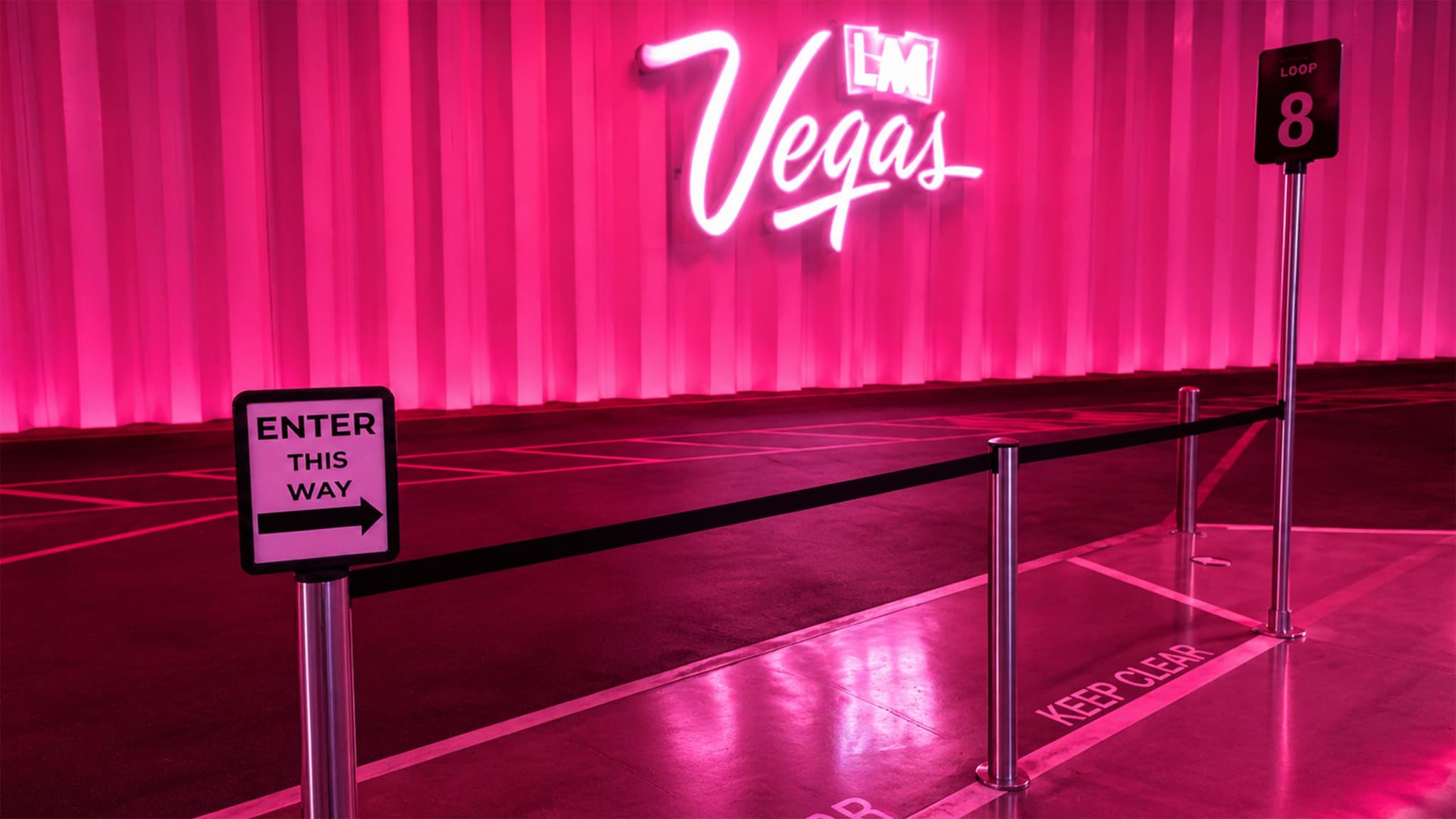 Beltrac stanchions with a post-top sign mark the pickup curb at the Vegas Loop station in Las Vegas.