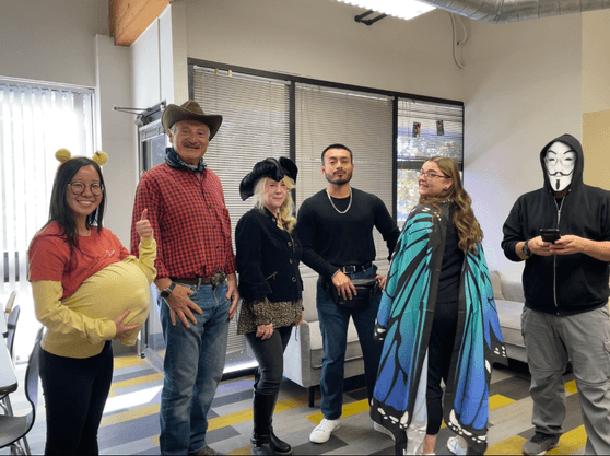 Lavi Industry employees in a row, showcasing their  Halloween costumes