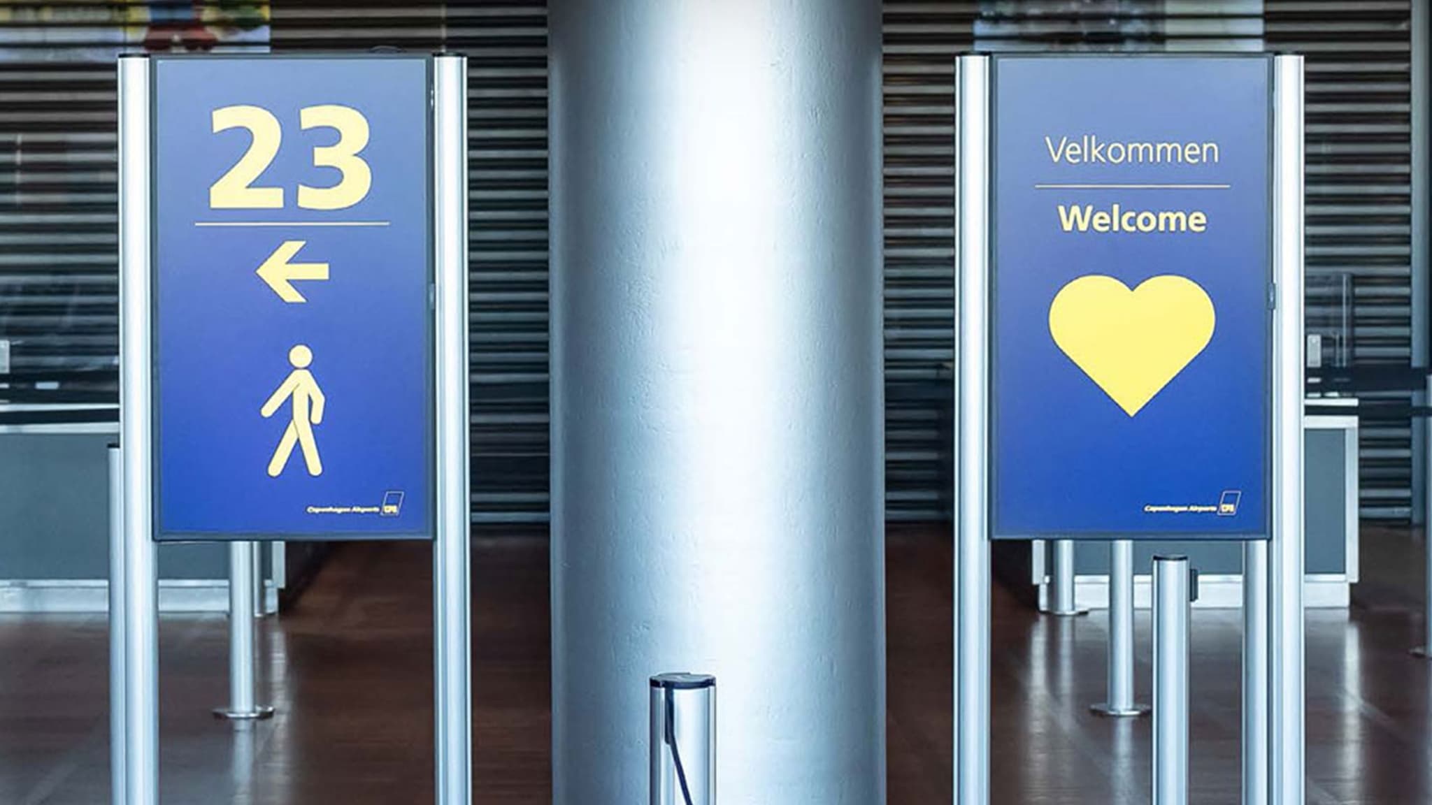 Digital signage in an Intelligent Queuing system shows lane status at an airport security checkpoint.