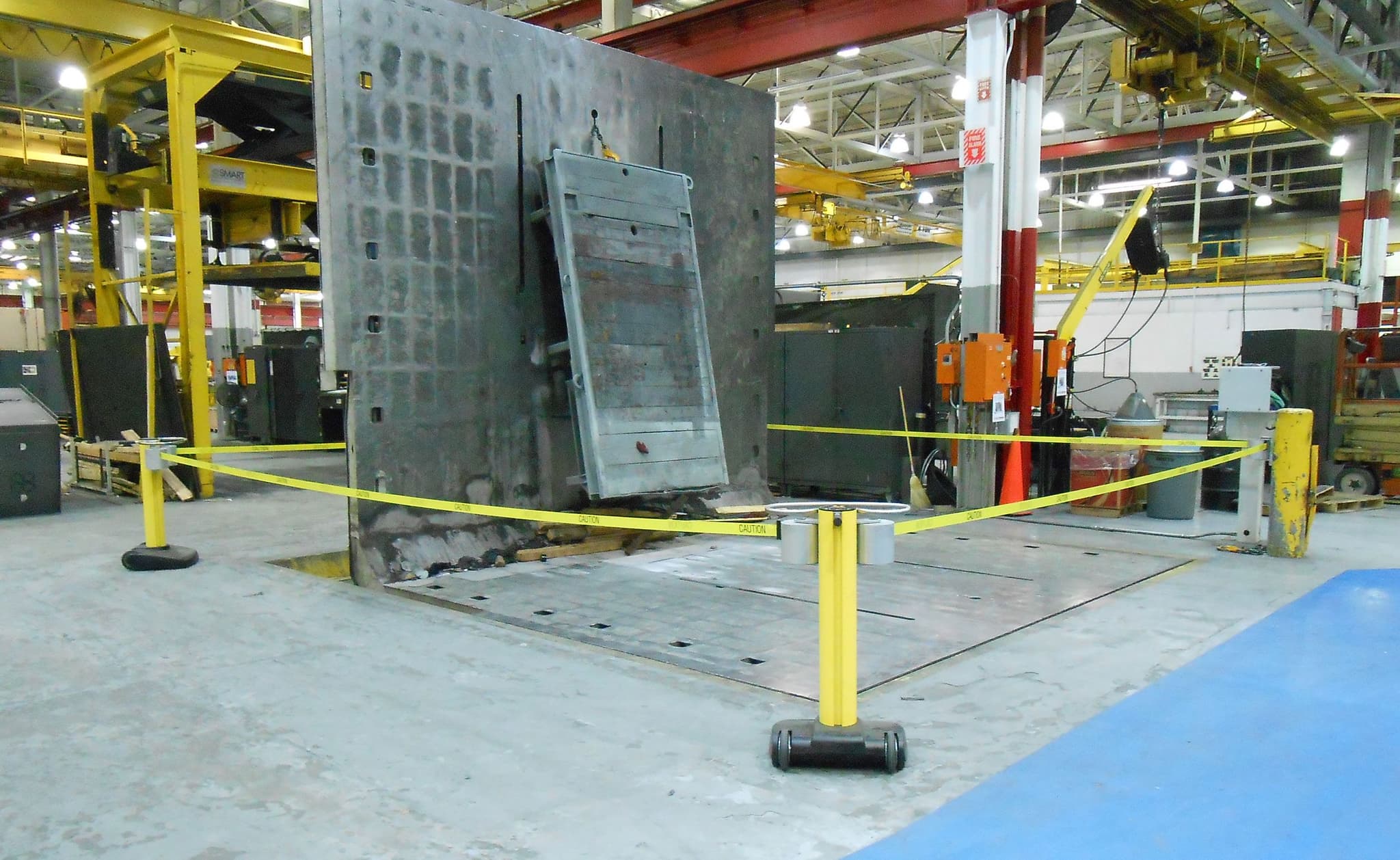 A JetTrac Dual mobile safety barrier blocks a work zone inside a warehouse.