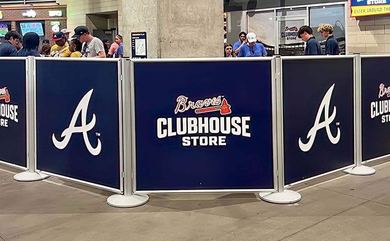 Post and Panel barriers with Braves graphics define the checkout area of the Atlanta Braves Clubhouse Store.