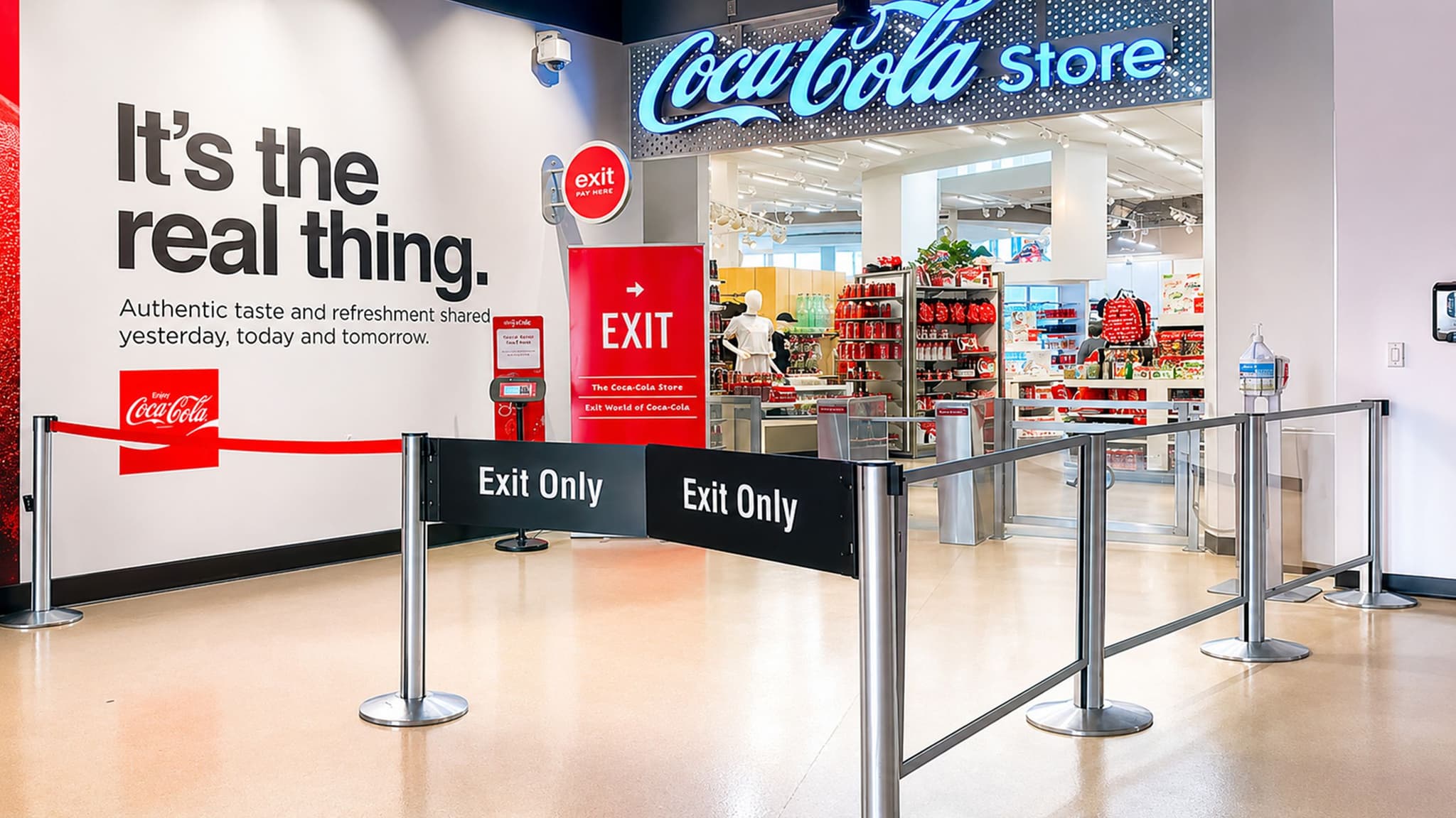 Beltrac stanchion swing gates and Rigid Rail barriers guide visitors through the exit at the World of Coca-Cola store.