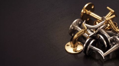 Handrail brackets in brass and stainless steel for commercial and residential railing systems