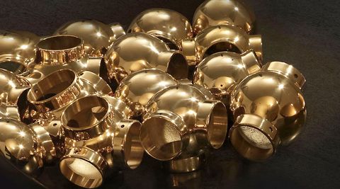 Polished brass ball fittings in a pile