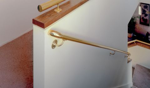 Brass wall handrail and short wall handrail on a stairway short wall
