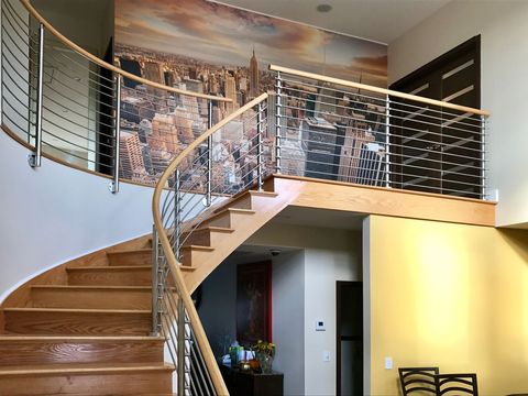 Cross Bar stair railing with wood handrail on curved staircase